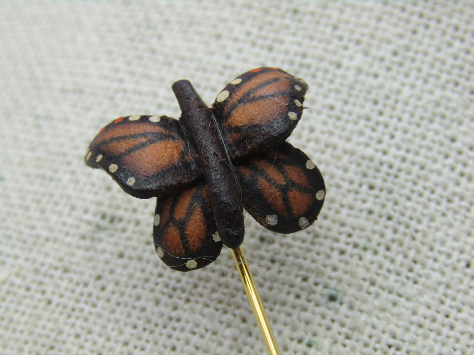 Vintage Orange Monarch Butterfly Stick Pin, 1970's, Gold Tone: Vintage Leather Orange Monarch Butterfly Stick Pin, 1970's, Gold Tone. 3.25" long with safety cap. The butterfly is leather, curved and signed LB on back. 3/4" wide and tall. Age unknown but would est