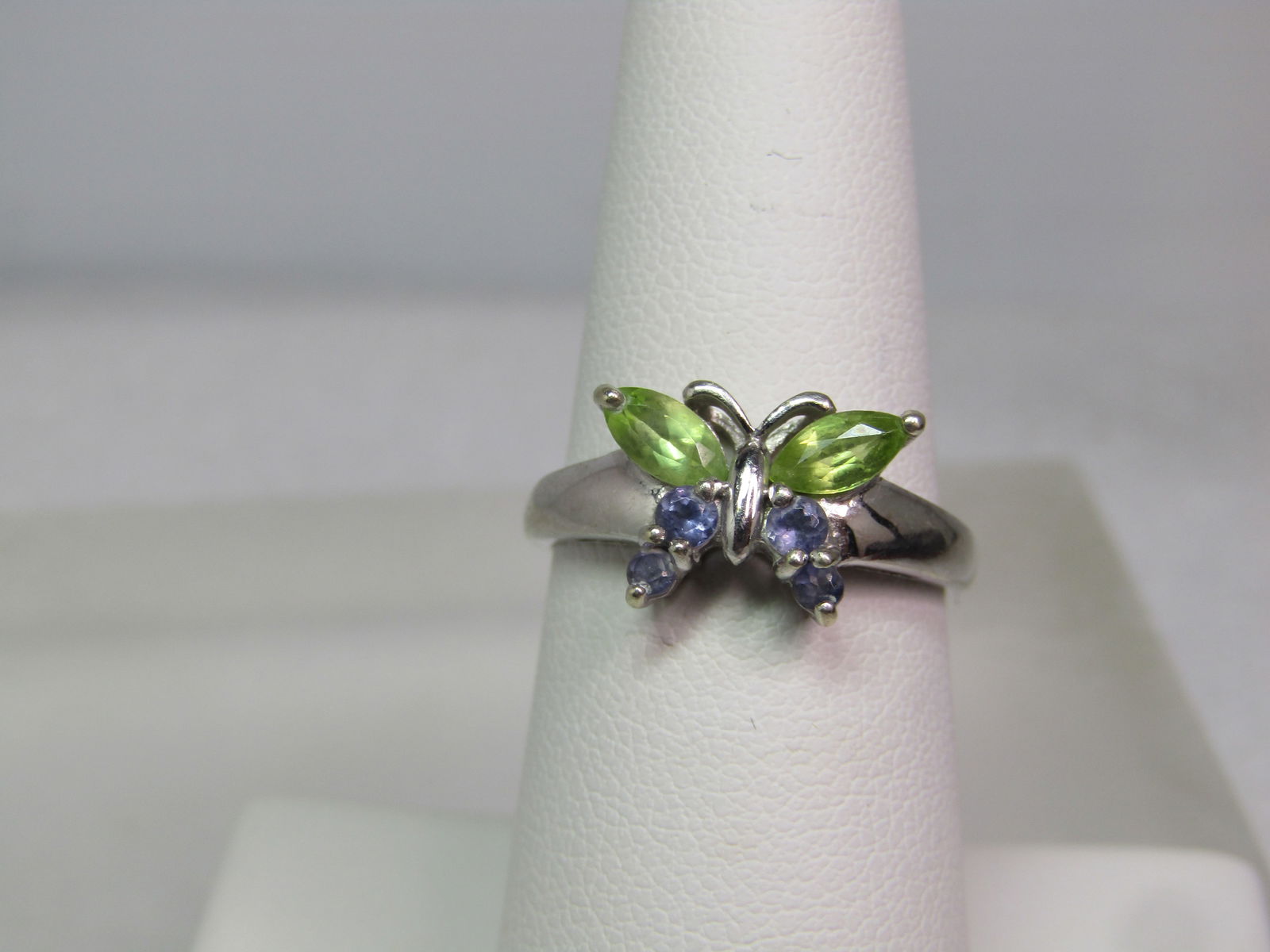 Vintage 10kt Gemstone Butterfly Ring, Sz. 7, 1980's, Signed: Vintage 10kt Gemstone Butterfly Ring, Sz. 7, 1980's, Signed UNG and also marked Thailand. The larger wings are peridot marquise stones that are appx. 5.5mm by 3mm and there are four lavender amethysts