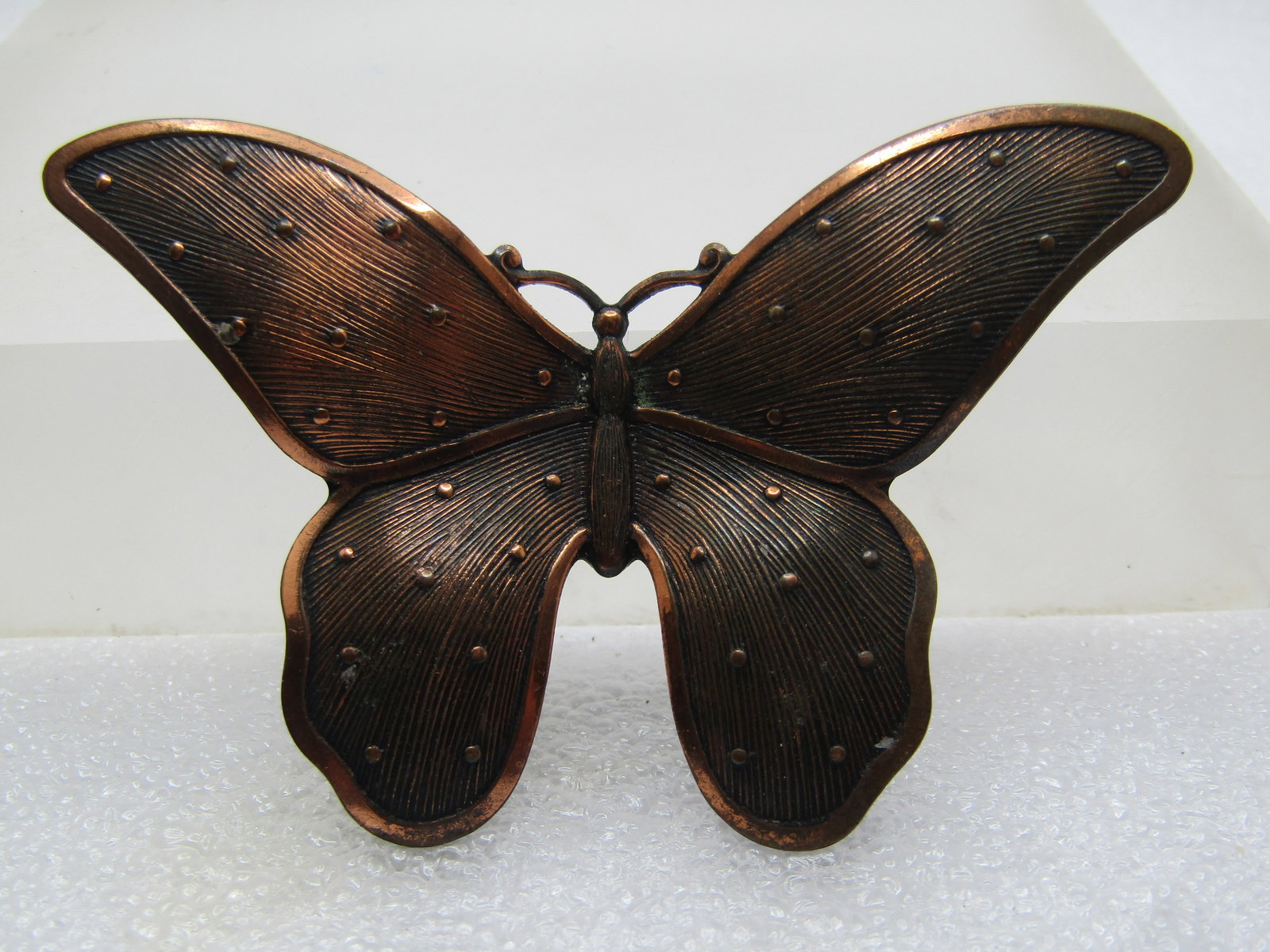 Vintage Coppertone Butterfly Brooch, 1970's, 2.75": Vintage Coppertone Butterfly Brooch, 1970's, 2.75" wide and 1.75" tall. It has a subtle ridged design in the wings with raised dotted accents and a slightly higher edge. The wings are curved