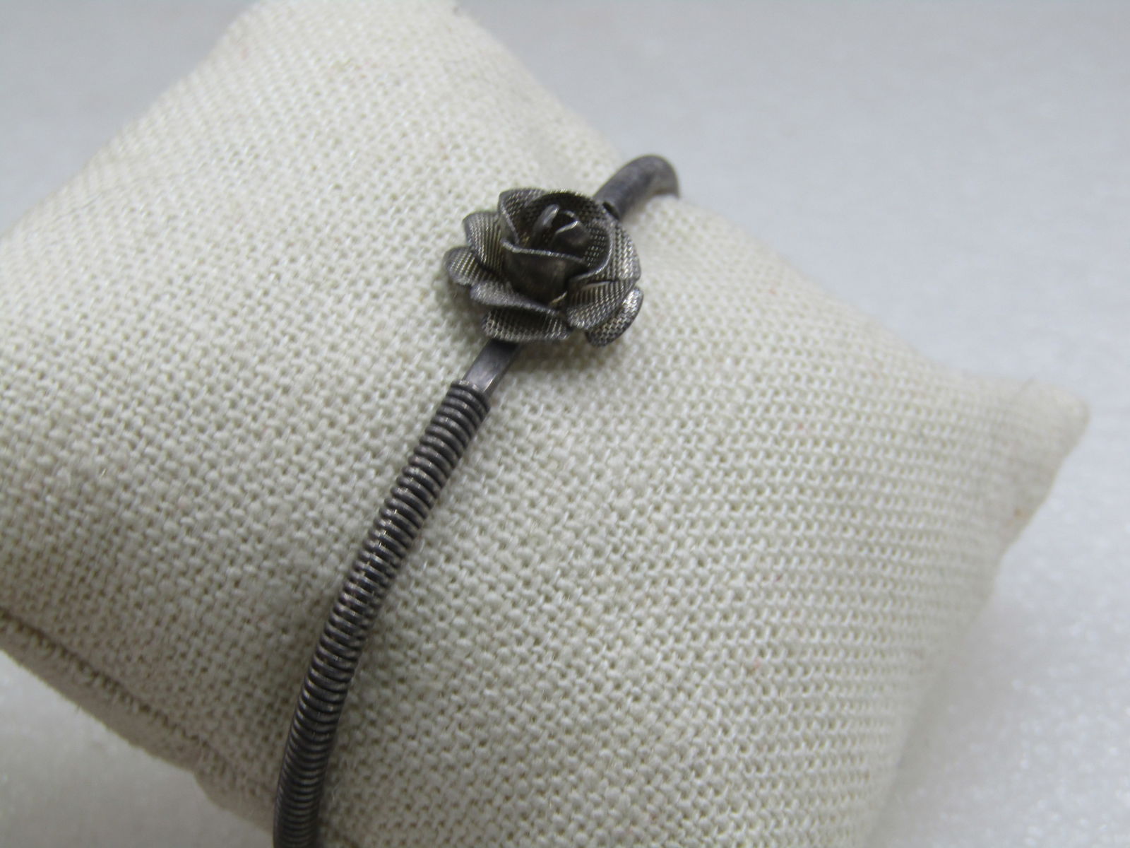Vintage Silver Tone Rose Blossom Cuff Bracelet 6": Vintage Silver Tone Rose Blossom Cuff Bracelet 6. This is 6" icnluding the opening in the back of the cuff. Thre is a 3-D rose blossom with textured finish on top of the wrist that is appx. 1/2". The