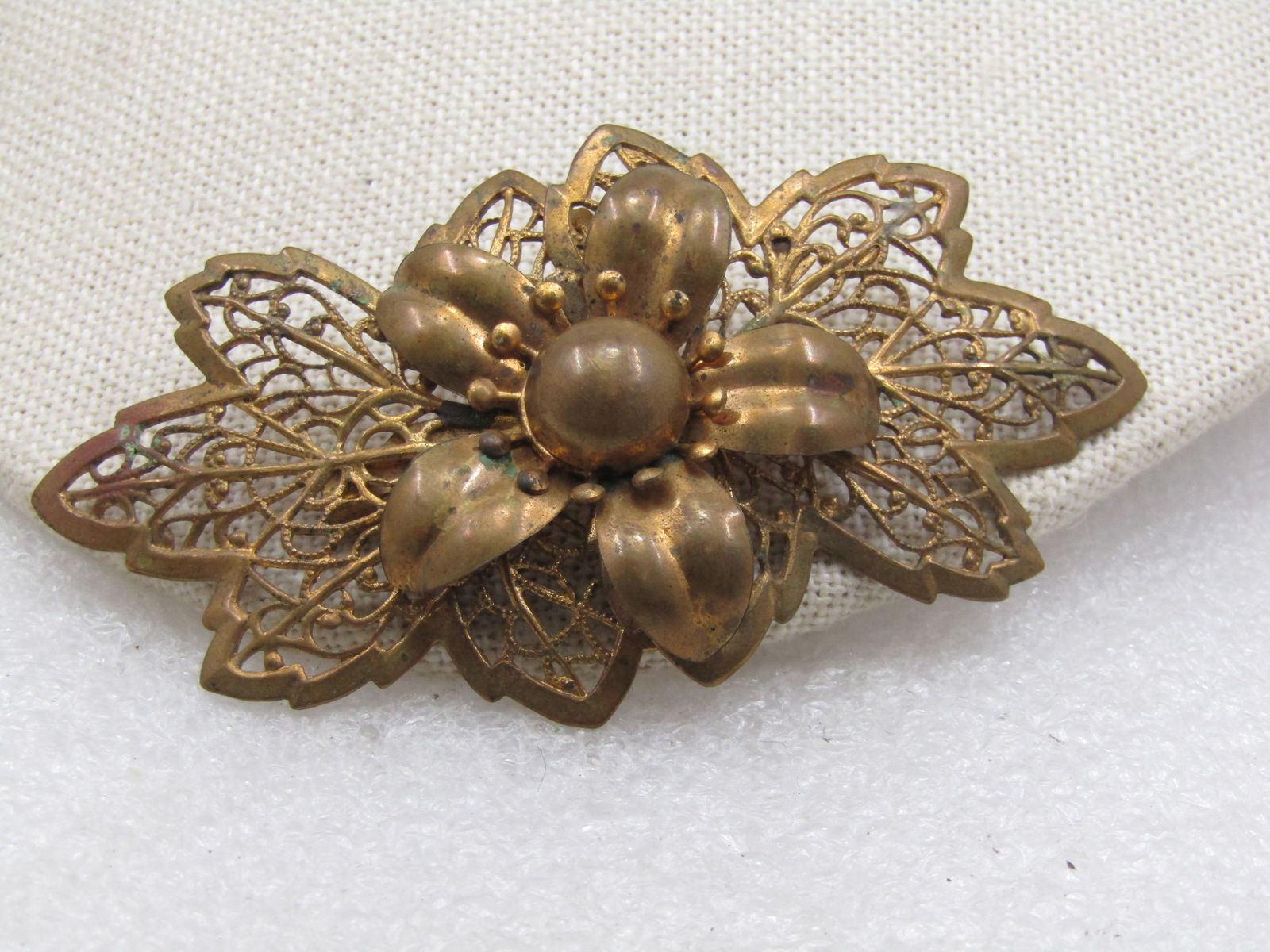 Victorian Filigree Floral Brooch, 3", C-Clasp: Victorian Filigree Floral Brooch, 3" wide and appx. 1.5" tall. , C-Clasp. Brassy gold tone in color with filigree leaves that have a solid framed edge with filigree veining with milgrain finish. On