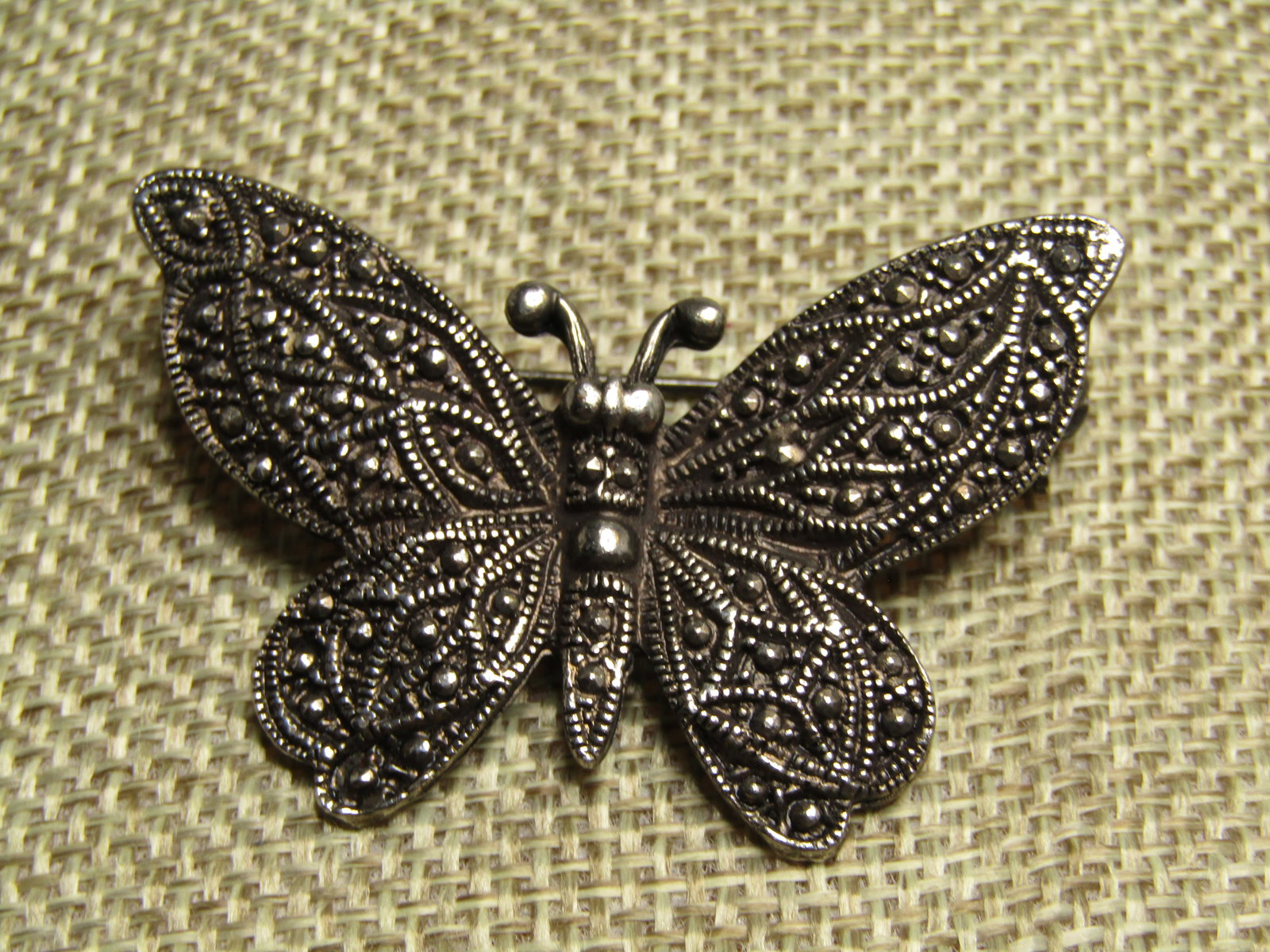 Vintage Butterfly Faux Marcasite Brooch, 1970's-1980's: Vintage Butterfly Faux Marcasite Brooch, 1970's-1980. Silver tone with raised edges and faux marcasite accents throughout. Locking clasp. It is appx. 2" by 1.25". It is not signed or marked. Very good