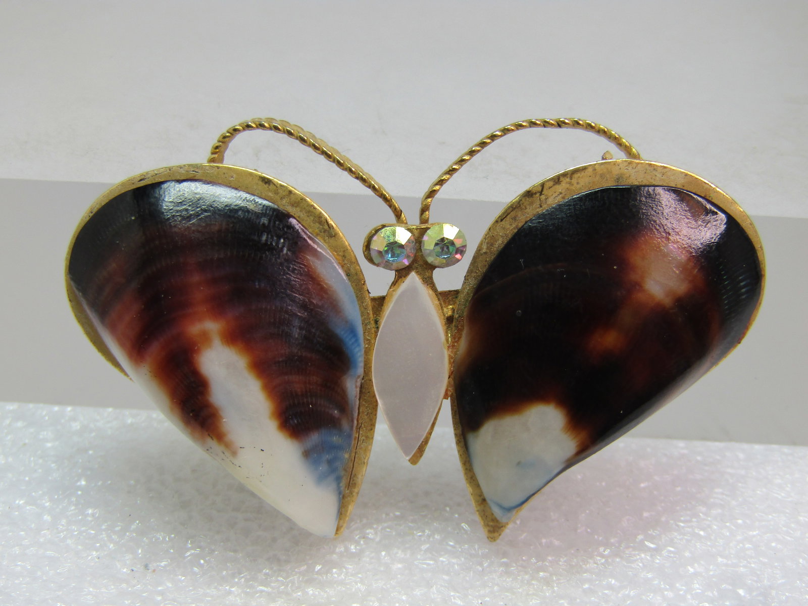 Vintage Butterfly/Moth Brooch, Shell Wings, MOP & AB RS, 1970's: Vintage Butterfly/Moth Brooch, Shell Wings, MOP & AB RS, 1970's. Brown and white raised shells on the wings create to wings with a pointed white mother-of-pearl torso and rainbow aurora borealis rhine