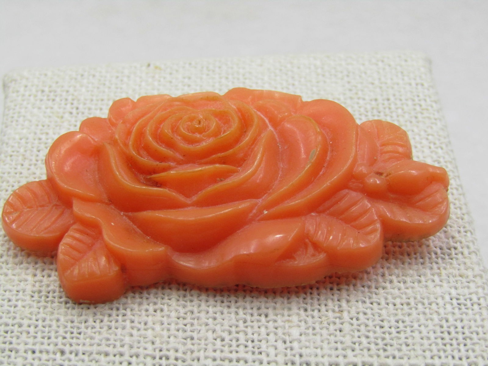 Vintage Celluloid Rose Brooch, Salmon Colored, C-Clasp. 1930's: Vintage Celluloid Rose Brooch, Salmon Colored, C-Clasp. 1930's. 2.25" wide and 1.25" tall. A rosed blossom is the main focus of the brooch with leaves off to each side. C-Clasp safety pin type pinback