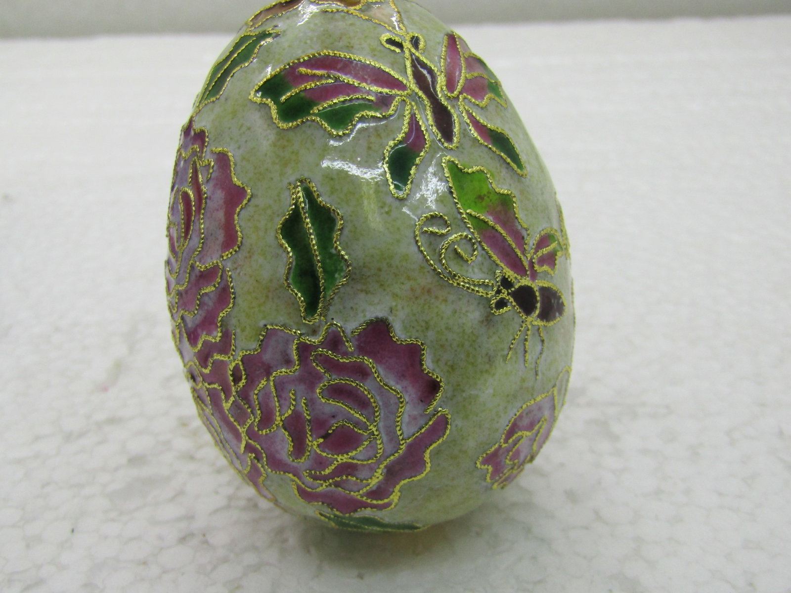 Cloissonne Egg, Butterfly & Rose Design, 2.5": Cloissonne Butterfly & Rose Design in pinks, green, white and more. 2.5" tall and nearly 2" across, with gold cord for hanging. Vintage new stock. Very good condition. (INV.w.12X19.5 SS1664 J LD 5/31/