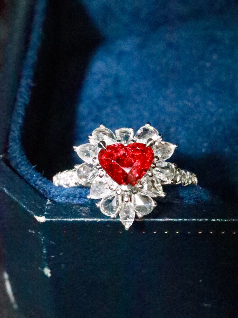 18K Gold Ruby Ring: Title: 18K Gold Ruby Ring Description: This ruby ring showcases a captivating pigeon blood hue, renowned for its vivid and enchanting color. The unheated ruby at its heart is a testament to natural be