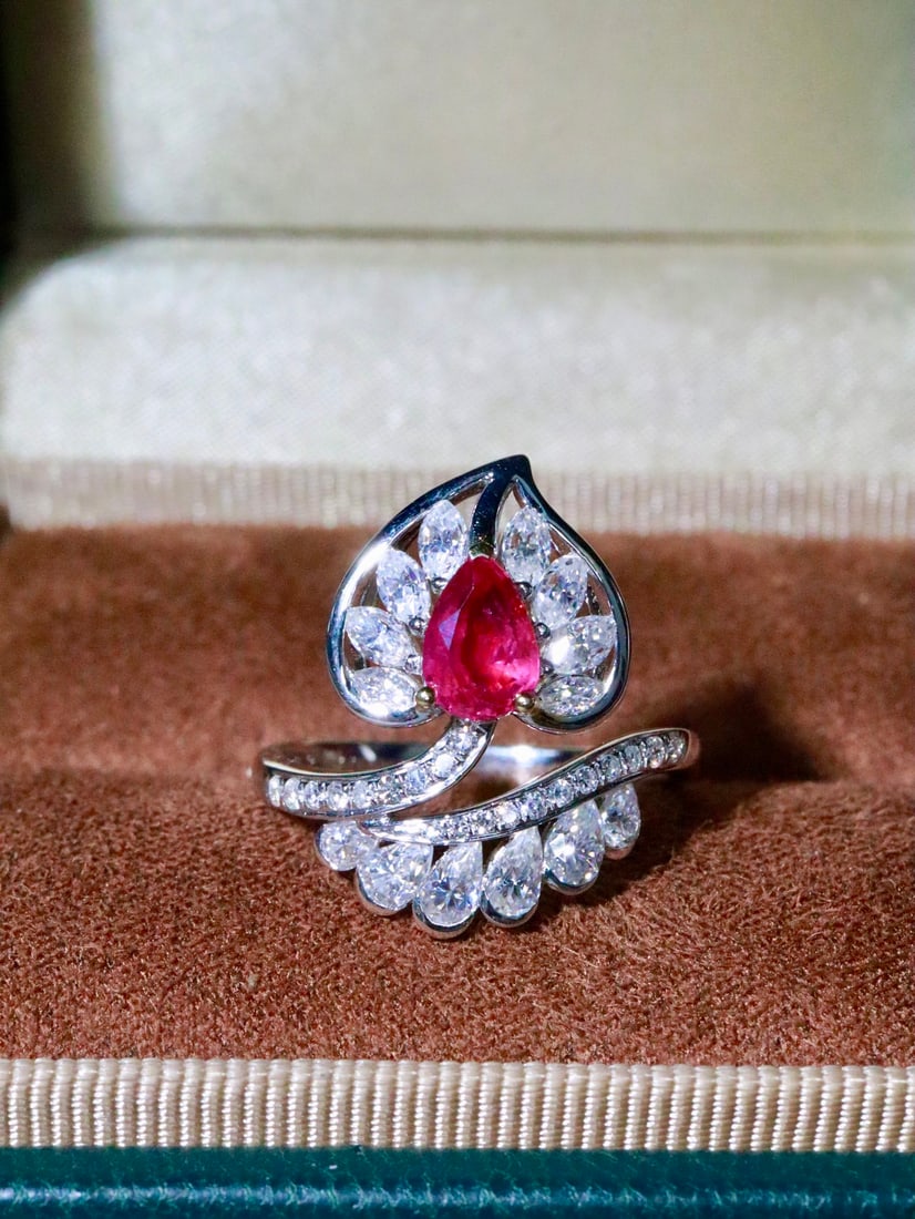 18K Gold Ruby Ring: Title: 18K Gold Ruby Ring Description: This 18K Gold Ruby Ring embodies an elegant and sophisticated charm, capturing the essence of timeless beauty. The main stone, an unheated ruby, dazzles with its