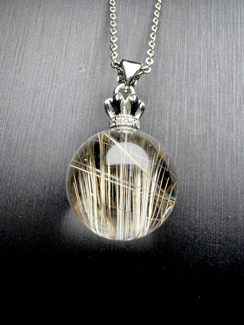 18K Gold Rutilated Quartz Pendant: Title: 18K Gold Rutilated Quartz Pendant Description: This exquisite 18K Gold Rutilated Quartz Pendant showcases a stunning natural rutilated quartz that gleams with a brilliant golden hue. Its clean
