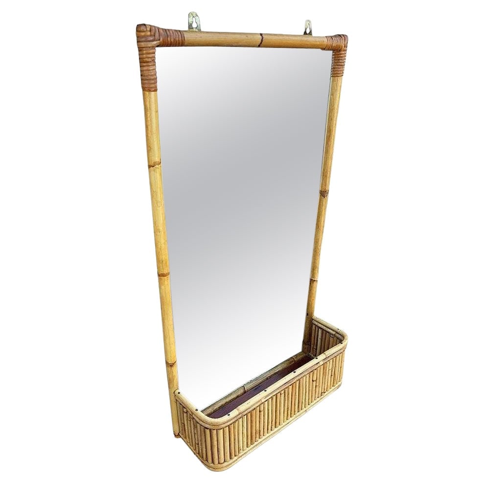 Restored Mid-century Stacked Rattan & Wicker Wall Mirror with Shelf/Planter: Title: Restored Mid-century Stacked Rattan & Wicker Wall Mirror with Shelf/Planter Description: Elevate your decor with this restored Mid-century Paul Frankl inspired rattan wall mirror featuring a tr