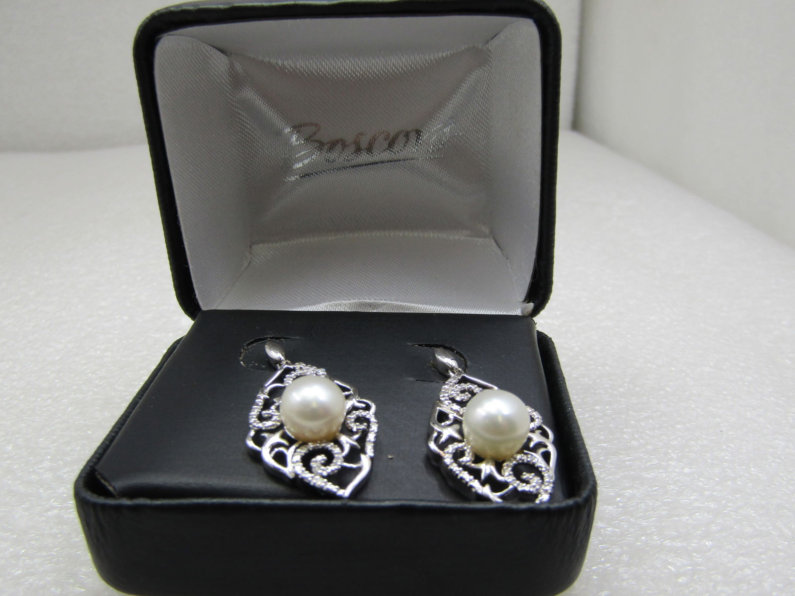 Sterling Pearl & Diamond Filigree Drop Earrings, Pierced. 8mm, .10 ctw: Title:Sterling Pearl & Diamond Filigree Drop Earrings, Pierced. 8mm, .10 ctwDescription:Sterling Pearl & Diamond Filigree Drop Earrings, Pierced. 8mm, .10 ctwThey have a cat-eye shaped stud from