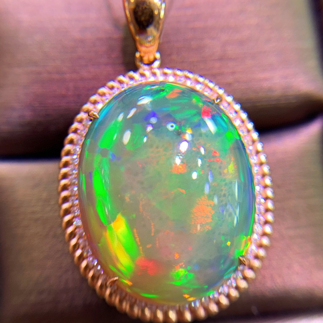 14K GOLD 14 CT NATURAL OPAL & DIAMOND PENDANT: Title:14K GOLD 14 CT NATURAL OPAL & DIAMOND PENDANTDescription:Ref:230528651Gold Content:14K GoldMain Gemstone:OpalNumber of stones:1Shape:OvalCarat Weight:14ct Color:ColorTreatment:NaturalCut