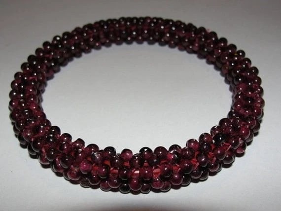 Great Red Garnet Beaded Bangle Bracelet: Title:Great Red Garnet Beaded Bangle Bracelet Description:Lovely Deep Red Garnet Beaded Bracelet. Circa 1950's. Each bead is 3 mm's. Bracelet is 10 mm's in diameter. Inside is 2 1/2". Woven around a f