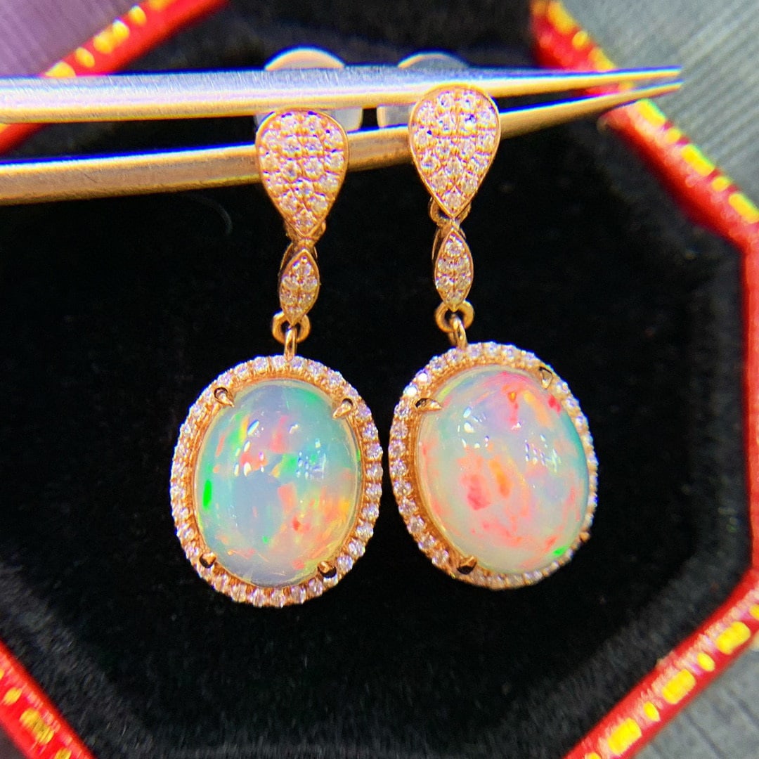 14K GOLD 2.3 CT NATURAL OPAL & DIAMOND EARRINGS: Title:14K GOLD 2.3 CT NATURAL OPAL & DIAMOND EARRINGSDescription:Ref:230528612Gold Content:14K GoldMain Gemstone:OpalNumber of stones:2Shape:OvalCarat Weight:2.3ct Color:WhiteTreatment:NaturalCut