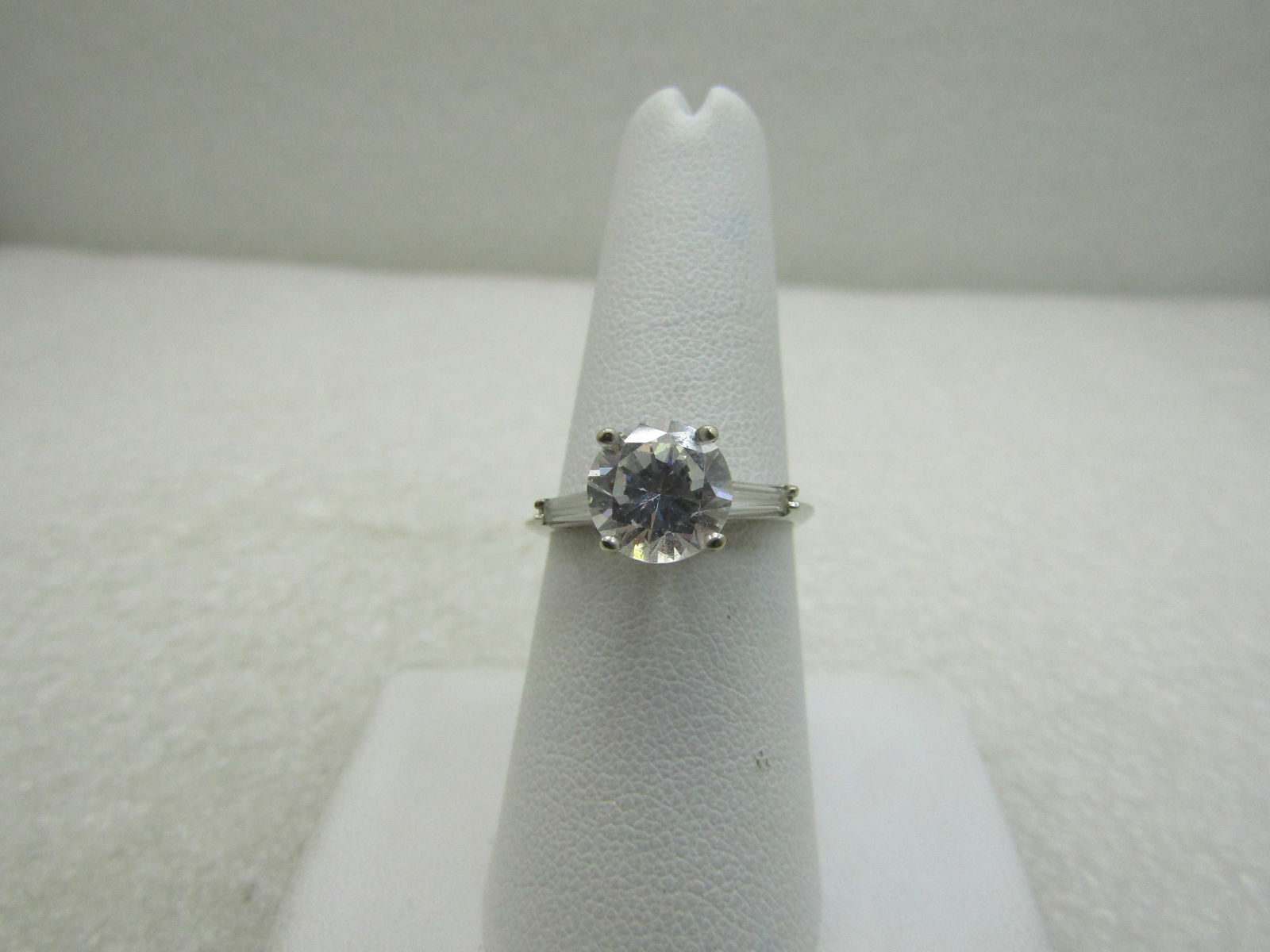 14kt CZ Engagement Ring, with Baguettes, Diamonique, 2.5+ TCW, Sz. 8, 3.42 Gr.: Title:14kt CZ Engagement Ring, with Baguettes, Diamonique, 2.5+ TCW, Sz. 8, 3.42 Gr.Description:14kt CZ Engagement Ring, with Baguettes, 2.5+ TCW, Sz. 8, 3.42 Gr. Diamonique 14kt White gold marked