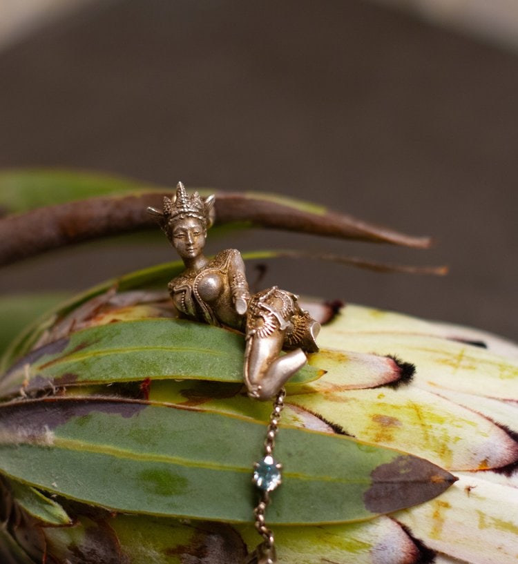 Silver Celestial Dancer Devata Pendant with Tourmaline: Title:Silver Celestial Dancer Devata Pendant with TourmalineDescription:This Devata pendant, depicting a celestial dancer, is crafted in sterling silver and set with a natural tourmaline.Designed by