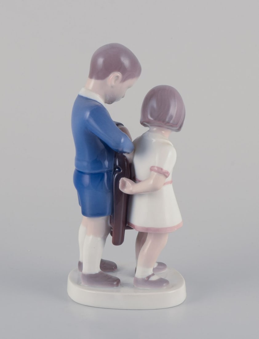 Bing & Grondahl, porcelain figurine. Boy helping girl with her jacket. Ca. 1930s - 2