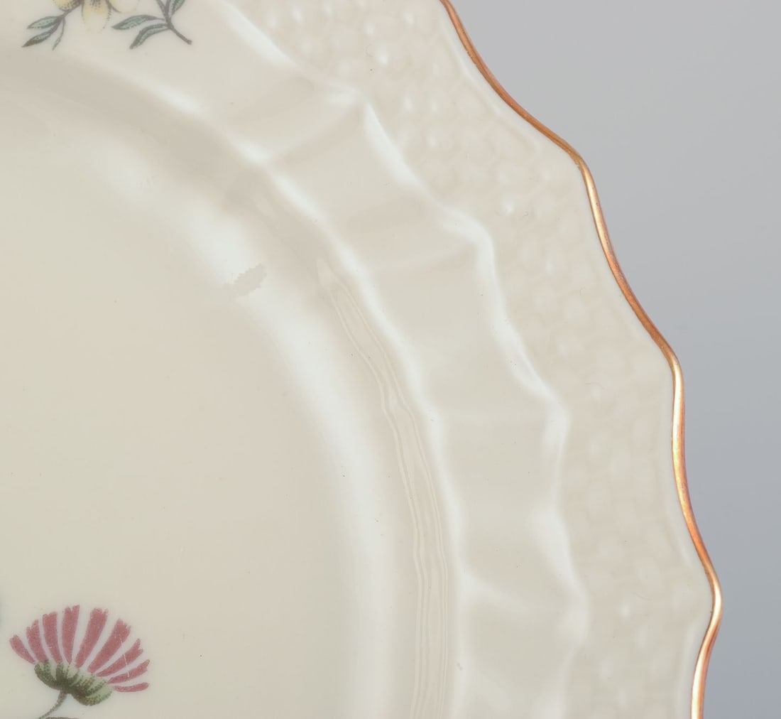 Royal Copenhagen, "Frijsenborg". Twelve plates decorated with floral motifs, gold rim. 1950s. - 7