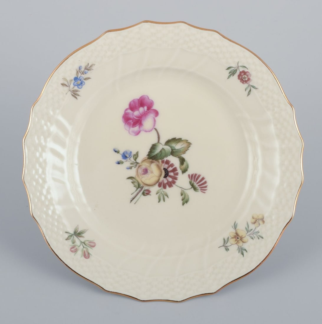 Royal Copenhagen, "Frijsenborg". Thirteen plates decorated with floral motifs, gold rim. 1950s. - 2
