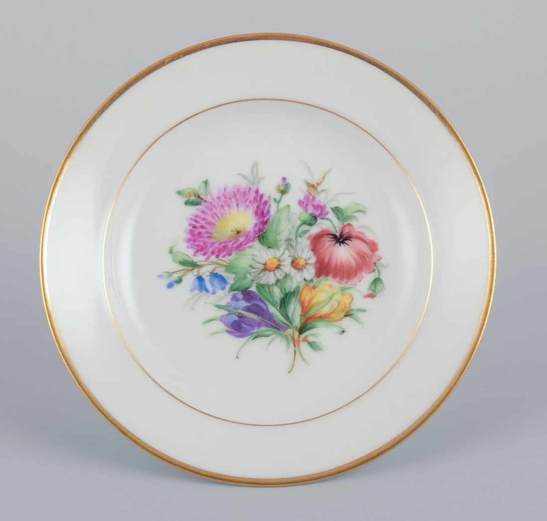 Bing & Grøndahl, set of four small plates with floral motifs and gold rim. Approx. 1920s. - 2