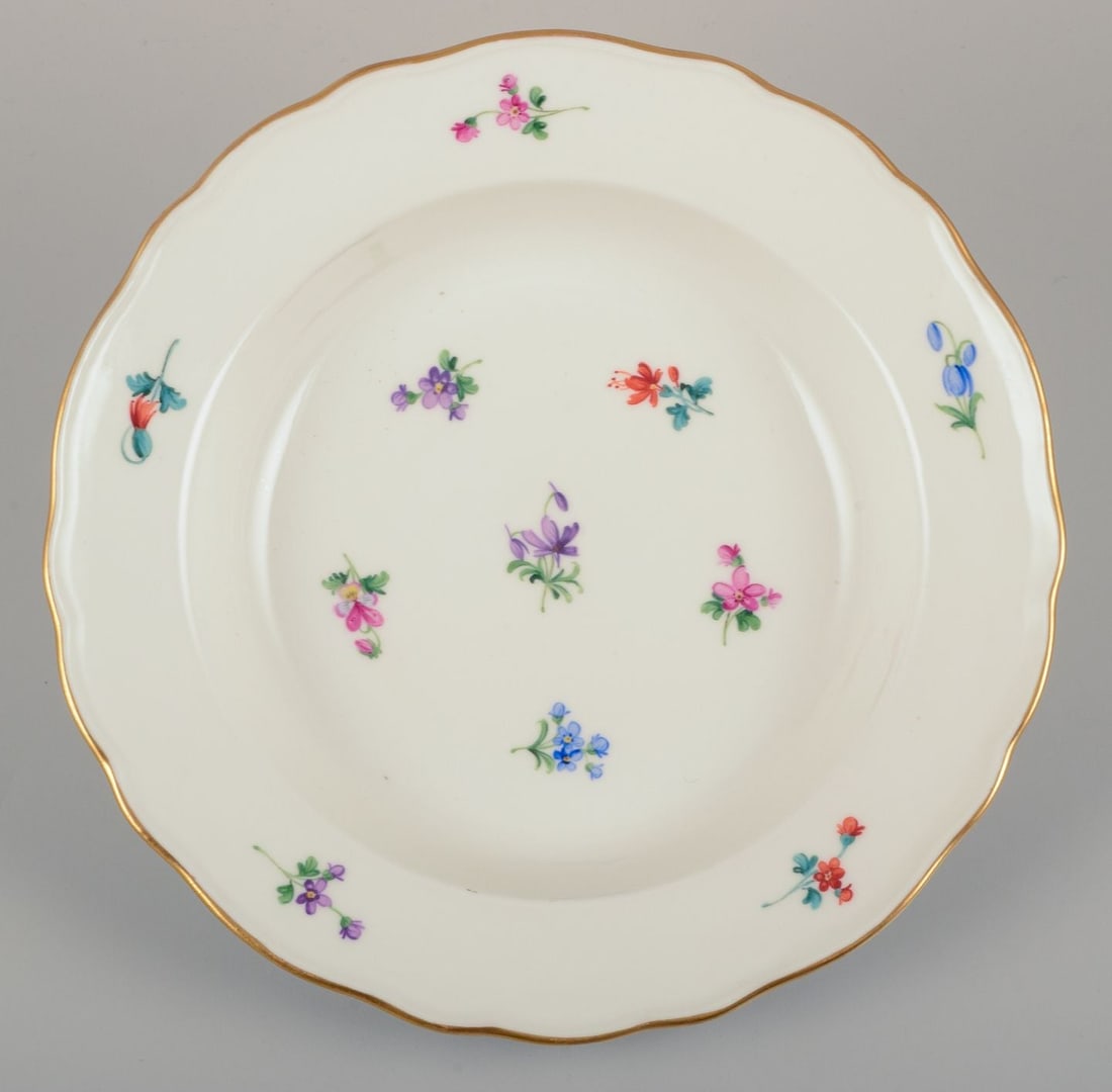 Meissen, Germany. A set of four deep plates in porcelain with polychrome floral motifs and gold rim. - 2