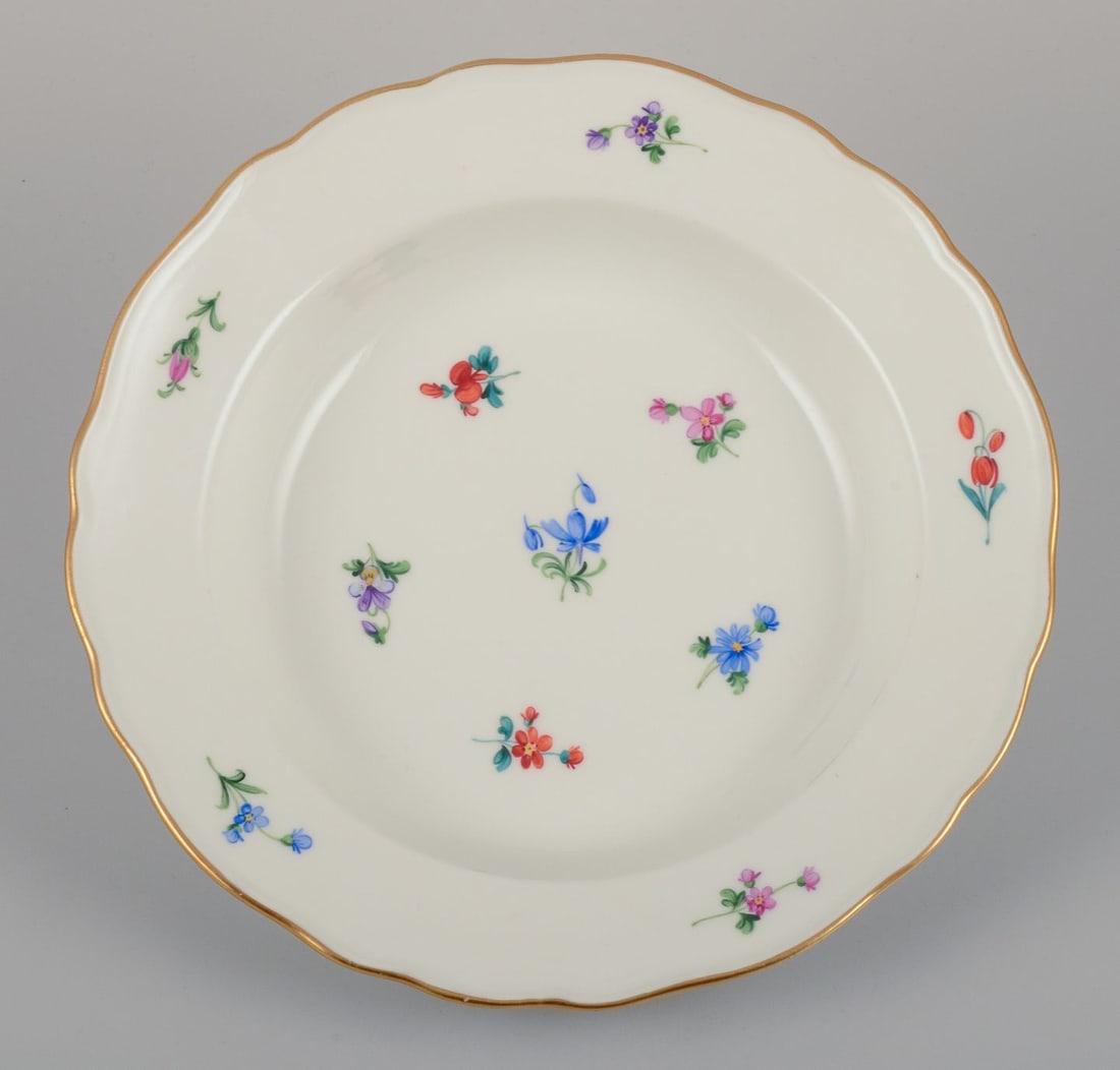 Meissen, Germany. A set of four deep plates in porcelain with polychrome floral motifs and gold rim. - 4