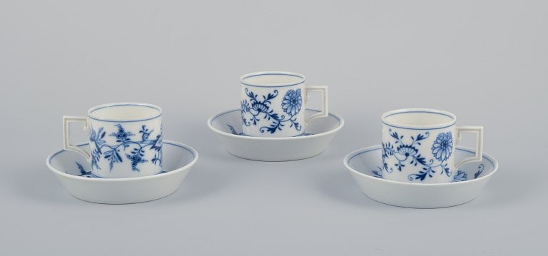 Meissen, Germany. Blue Onion. A set of three small chocolate cups with saucers. Hand-decorated with: Title: Meissen, Germany. Blue Onion. A set of three small chocolate cups with saucers. Hand-decorated with blue flowers. Description: Meissen, Germany. Blue Onion. A set of three small chocolate cups