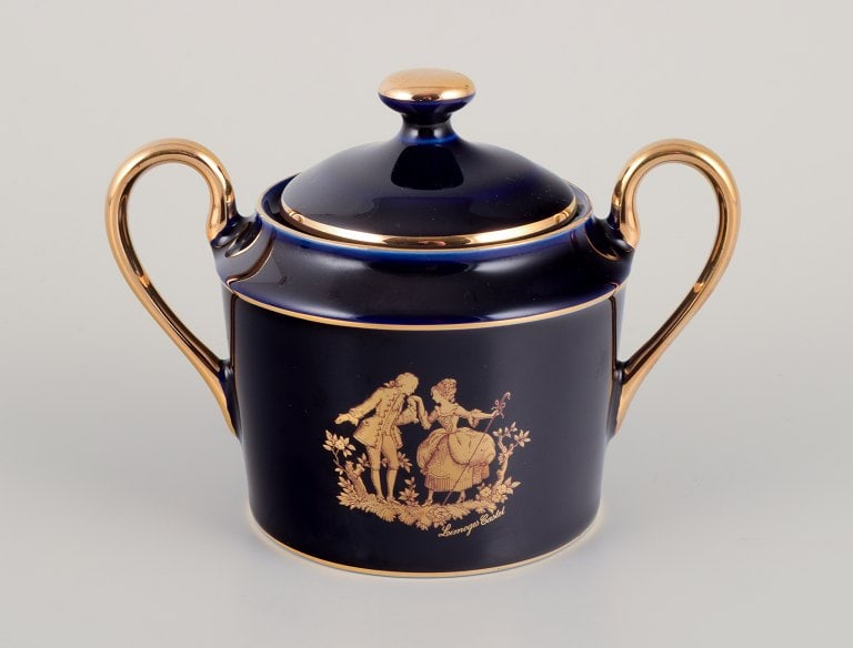 Limoges, France. Two pieces of porcelain consisting of a coffee cup and sugar bowl decorated with - 2