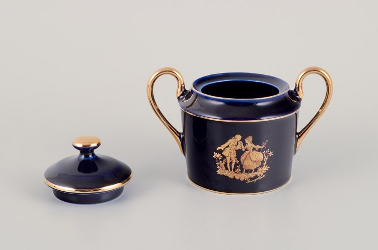 Limoges, France. Two pieces of porcelain consisting of a coffee cup and sugar bowl decorated with - 3