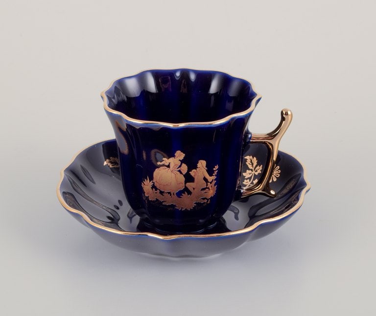 Limoges, France. Two pieces of porcelain consisting of a coffee cup and sugar bowl decorated with - 4