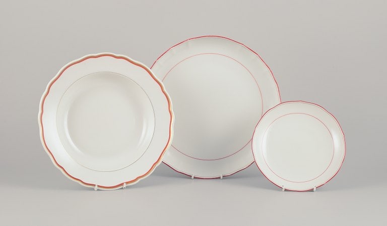 Meissen, Germany. Three-piece porcelain set consisting of a large bowl, a deep plate, and a plate.: Title: Meissen, Germany. Three-piece porcelain set consisting of a large bowl, a deep plate, and a plate. Decorated with coral red and gold-colored trim. Art Deco. Description: Meissen, Germany. Three