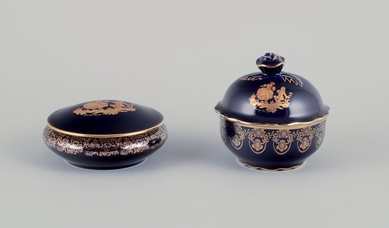 Limoges, France. Two porcelain lidded jars in porcelain, decorated with 22-karat gold leaf and: Title: Limoges, France. Two porcelain lidded jars in porcelain, decorated with 22-karat gold leaf and beautiful royal blue glaze. Scène galante. Description: Limoges, France. Two porcelain lidded