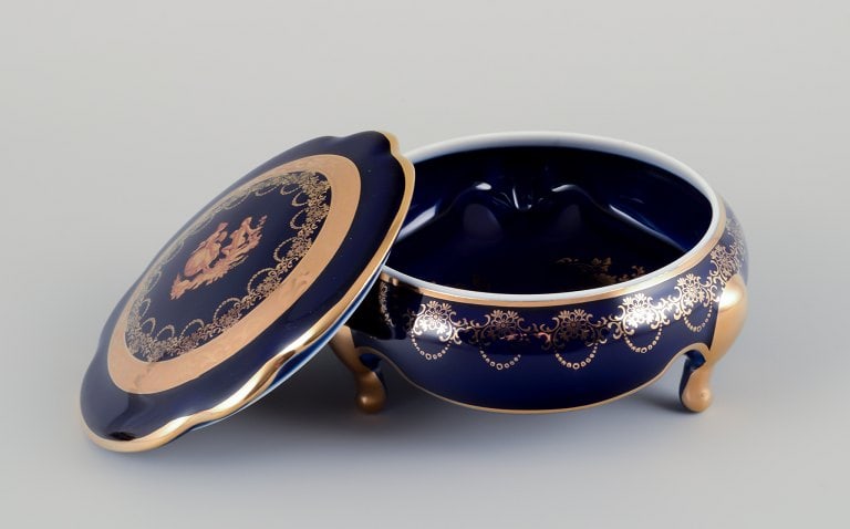 Limoges, France. Two lidded porcelain jars decorated with 22-karat gold leaf and featuring a - 3