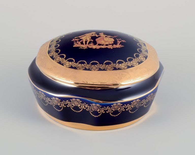 Limoges, France. Two lidded porcelain jars decorated with 22-karat gold leaf and featuring a - 5