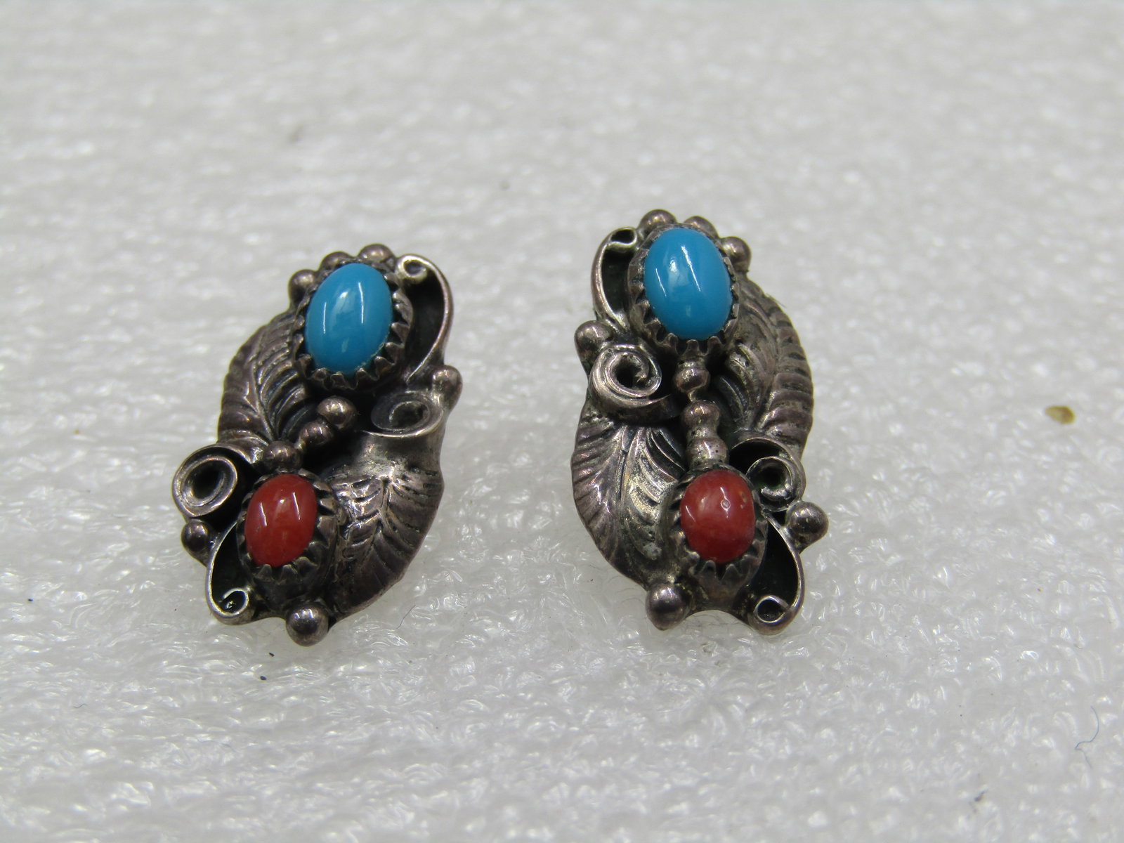 Vintage Sterling Southwestern Turquoise Coral Earrings Signed W.R.: Vintage Sterling Southwestern Turquoise Coral Earrings Signed W.R. Tested and are appx. 4.23 gr. Feather, bead and scrolled accents. Appx. 1960's-1970's. (W12222.2X7 SS6560 J MV LD 1/26/22). Reserve: