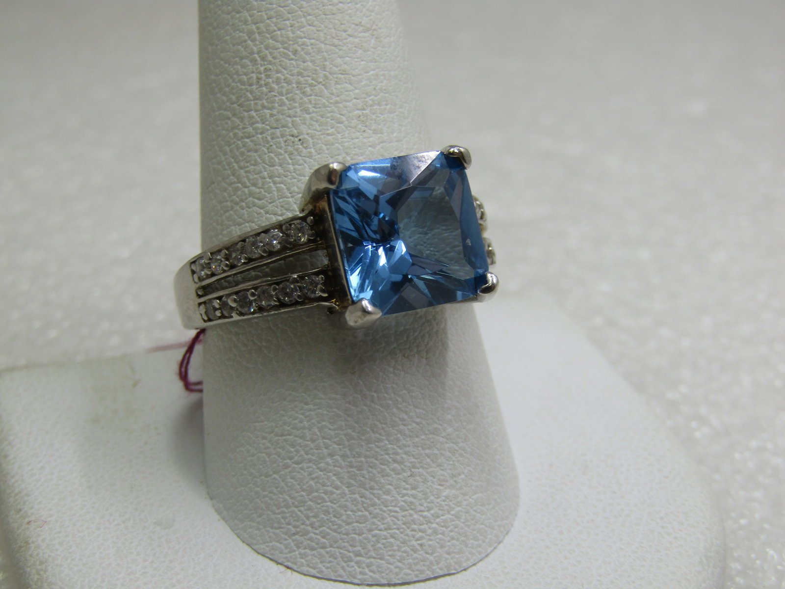 Sterling Created Blue Topaz CZ Ring, Sz. 10.5.: Sterling Created Blue Topaz CZ Ring, Sz. 10.5. CZ accents in the split band on each side. Created topaz is appx. 10mm square. Weight is 4.80 gr., tested and marked .925. Very good condition.