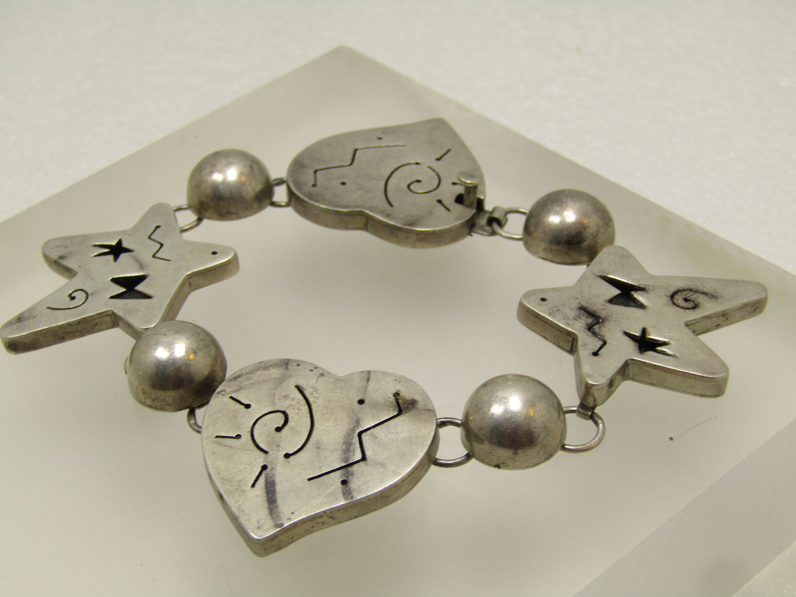 Vintage Sterling Hearts & Stars Bracelet, Thick Links 7" Signed Far Fetched, 1980's: Vintage Sterling Hearts & Stars Bracelet, Thick Links 7" Signed Far Fetched, 1980's. Far Fetched is a jewelry company, founded by Richard Wolf in the 1980s, known for its fun, heartfelt, and culturall