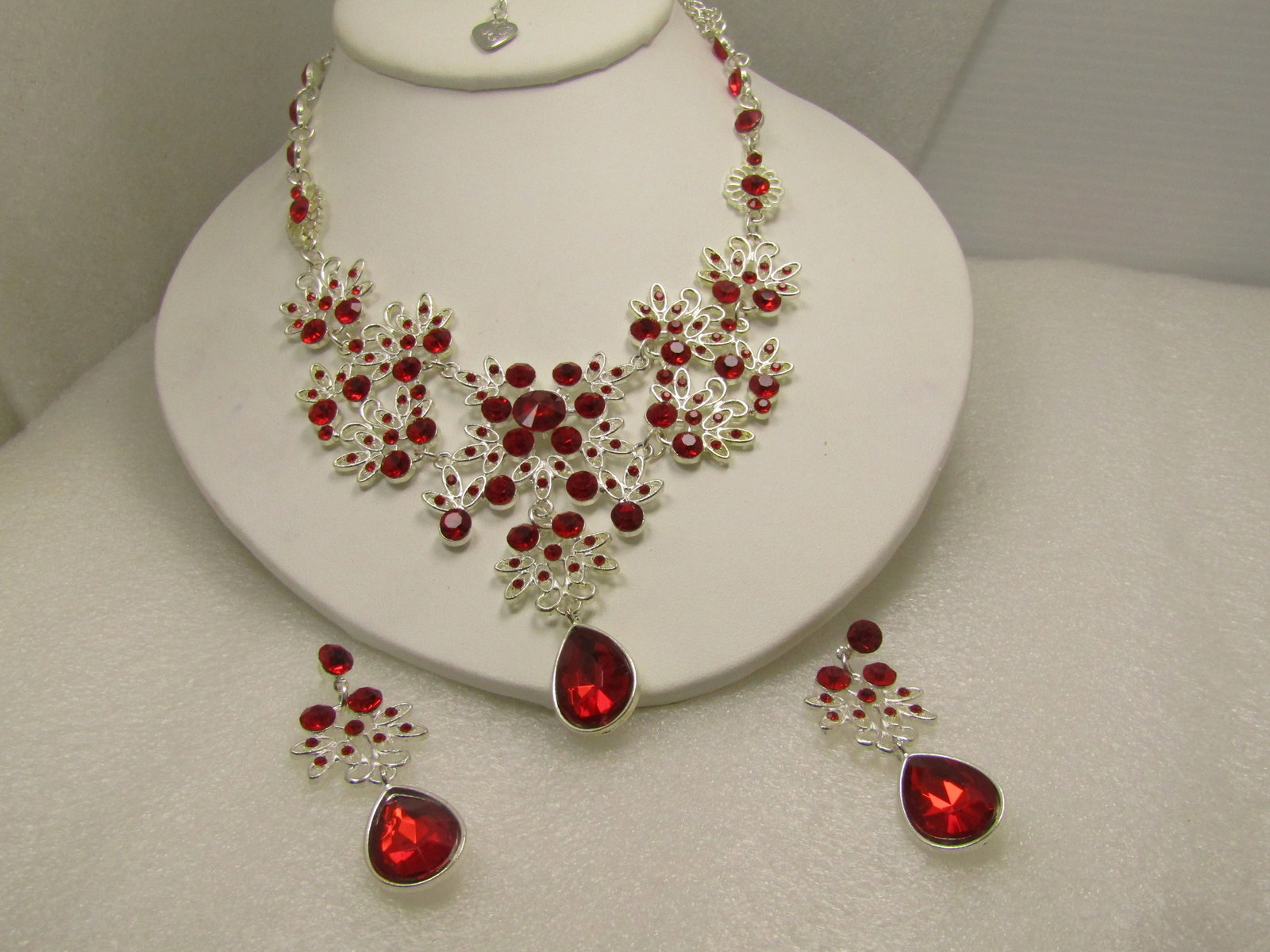 Vintage Silver Tone Red Rhinestone Bib Necklace & Earrings Set, Pierced, 23" Signed , 1990's and: Vintage Silver Tone Red Rhinestone Bib Necklace & Earrings Set, Pierced, 23.5" Signed with a heart tag that looks like PJ on one side and a two-word name on the back that I cannot read. Filigree silve