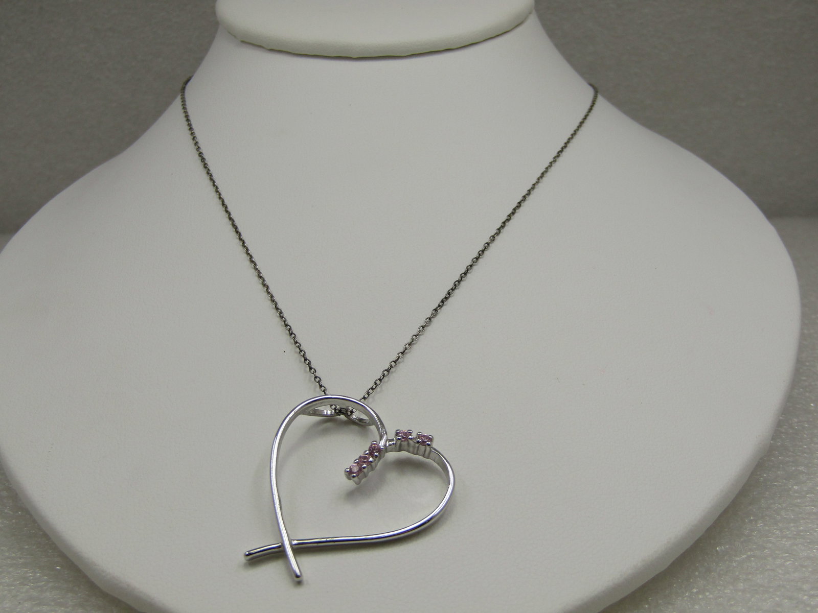 Sterling Heart Necklace, Pink Rhinestones, 20": Sterling Heart Necklace, Pink Rhinestones, 20". Heart is a modern design with overlapping points at the bottom. The pendant is 1.25" tall and wide with five pink rhinestones raised on the center