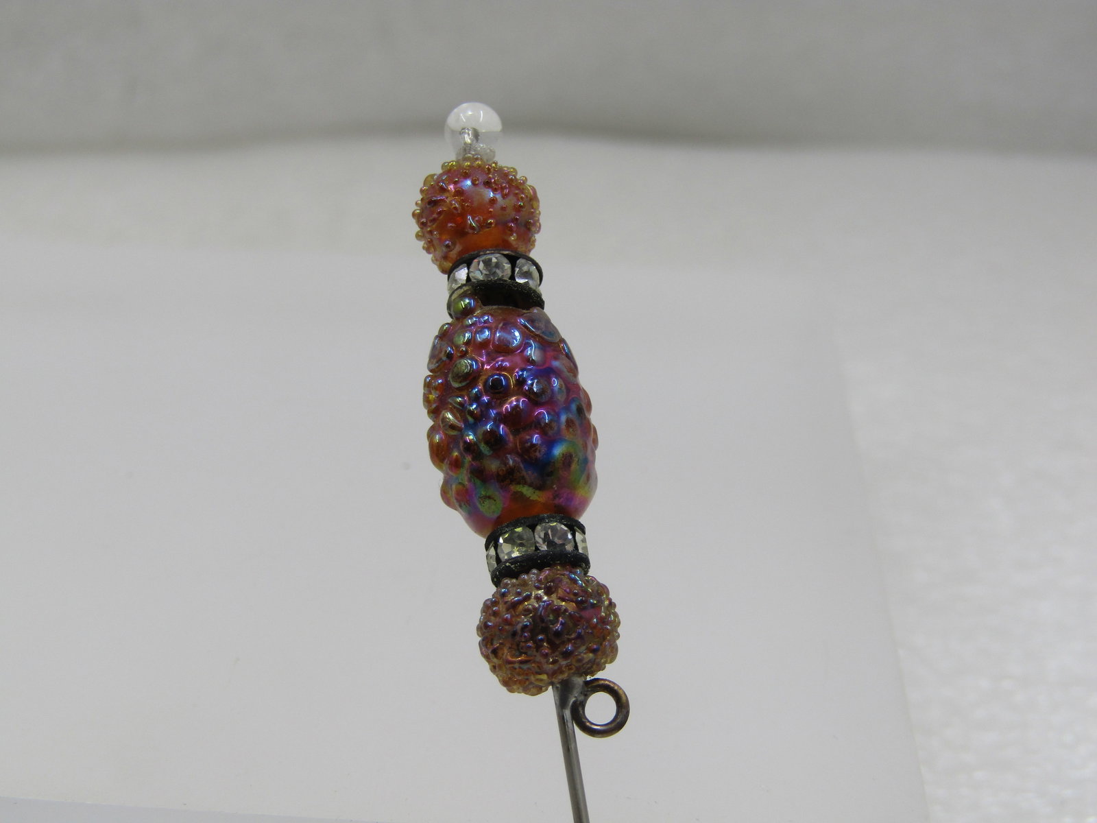 Vintage Amber Glass & Rhinestone Rondelle Stick Pin, 1940's: Vintage Amber Glass & Rhinestone Rondelle Stick Pin, 1940's. The glass beads are a pressed textured or designed glass with aurora borealis shimmer and have a rhinestone rondelle on each side of the ce
