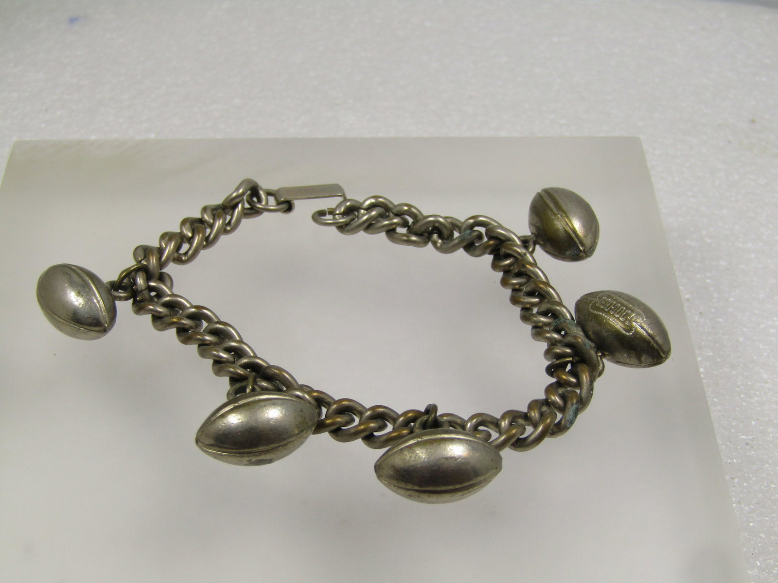 Vintage Football Charm Bracelet, 7", 1950's, Silver Tone: Vintage Football Charm Bracelet, 7", 1950's, Silver Tone. These were so popular bck when I was in school continuing in the 1960's-1970's. This bracelet has a 7" heavy appx. 7mm wide curb link chain wi