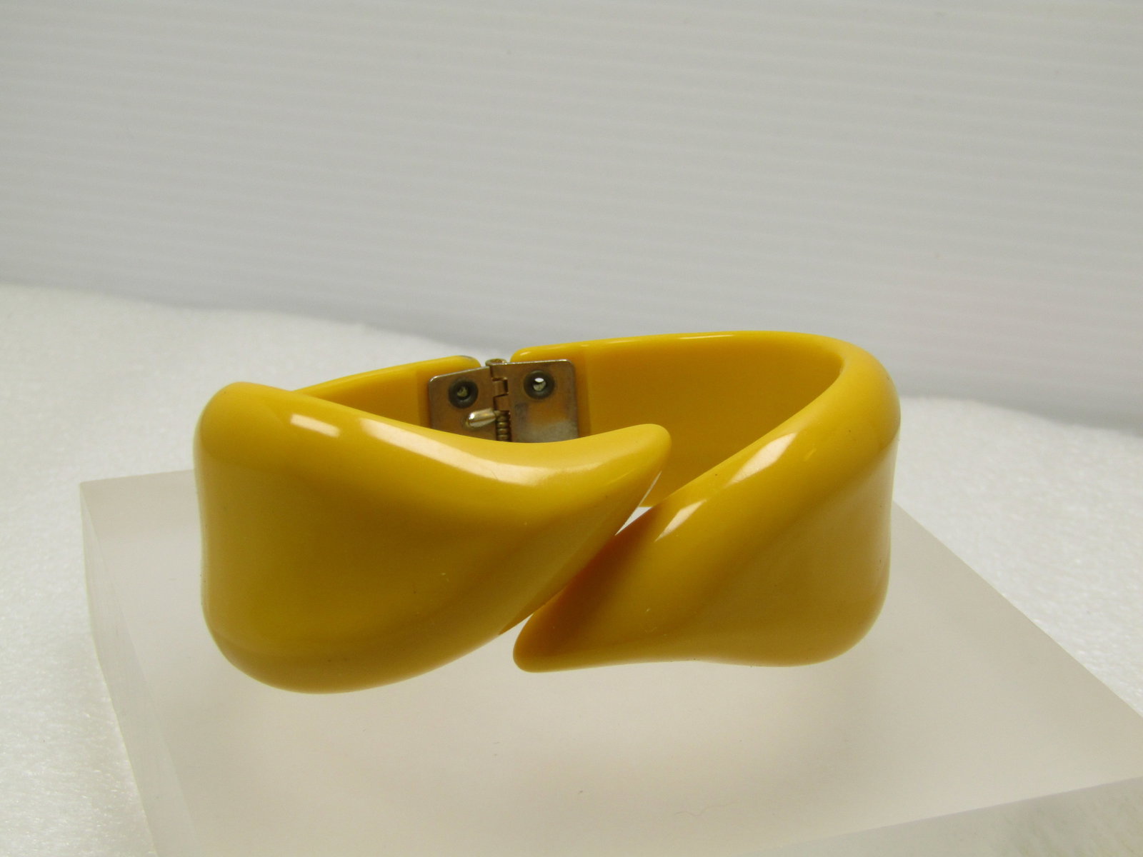 Vintage Yellow Acrylic Hinged Clamper Bracelet, 1950's-1960's, 7": Vintage Yellow Acrylic Hinged Clamper Bracelet, 1950's-1960's, 7". This has a bypass pointed top and is appx. 1-1/3" at the widest point on the two sides off of center - at center the bypass design co