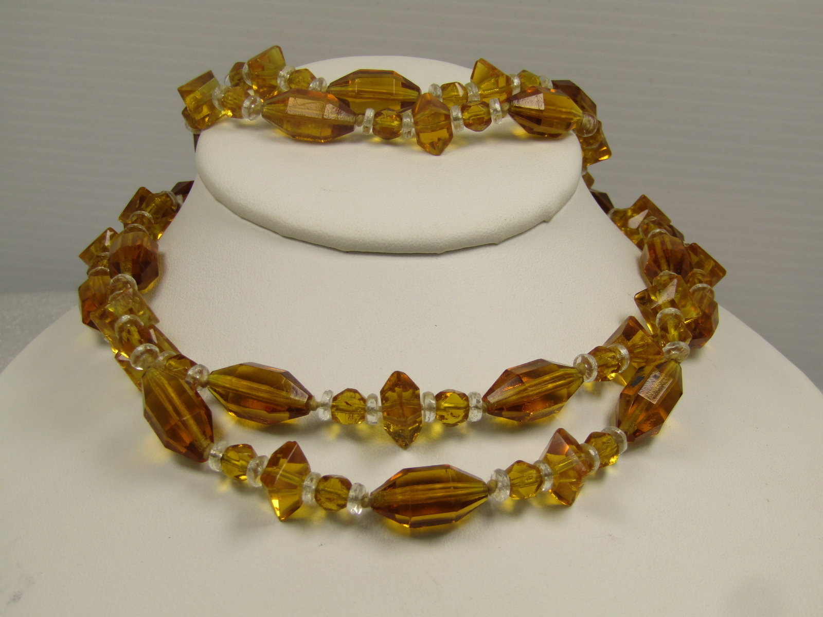 Vintage Amber & Clear Glass Beaded Necklce, 48", 1930's-1940's Knotted Between Beads: Vintage Amber & Clear Glass Beaded Necklce, 48", 1930's-`1940's Knotted Between Beads. These have long oblong faceted amber colored glass beads with small clear disc-like spacer beads and smaller roun