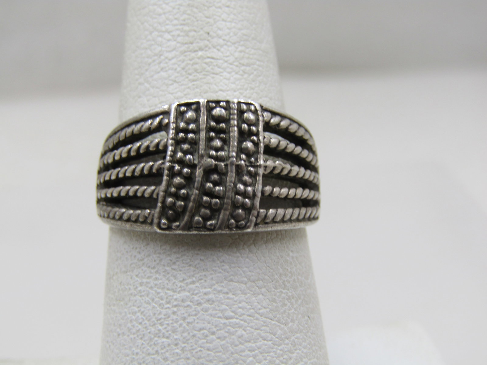 Vintage Sterling Wide Ring, Multi-Band Look, Sz, 7.5, 1970's: Vintage Sterling Wide Ring, Multi-Band Look, Sz, 7.5, 1970's-1980's. This has a faux marcasite look down the center in three rows in a slight curve. Off to the sides five rope accented bands that