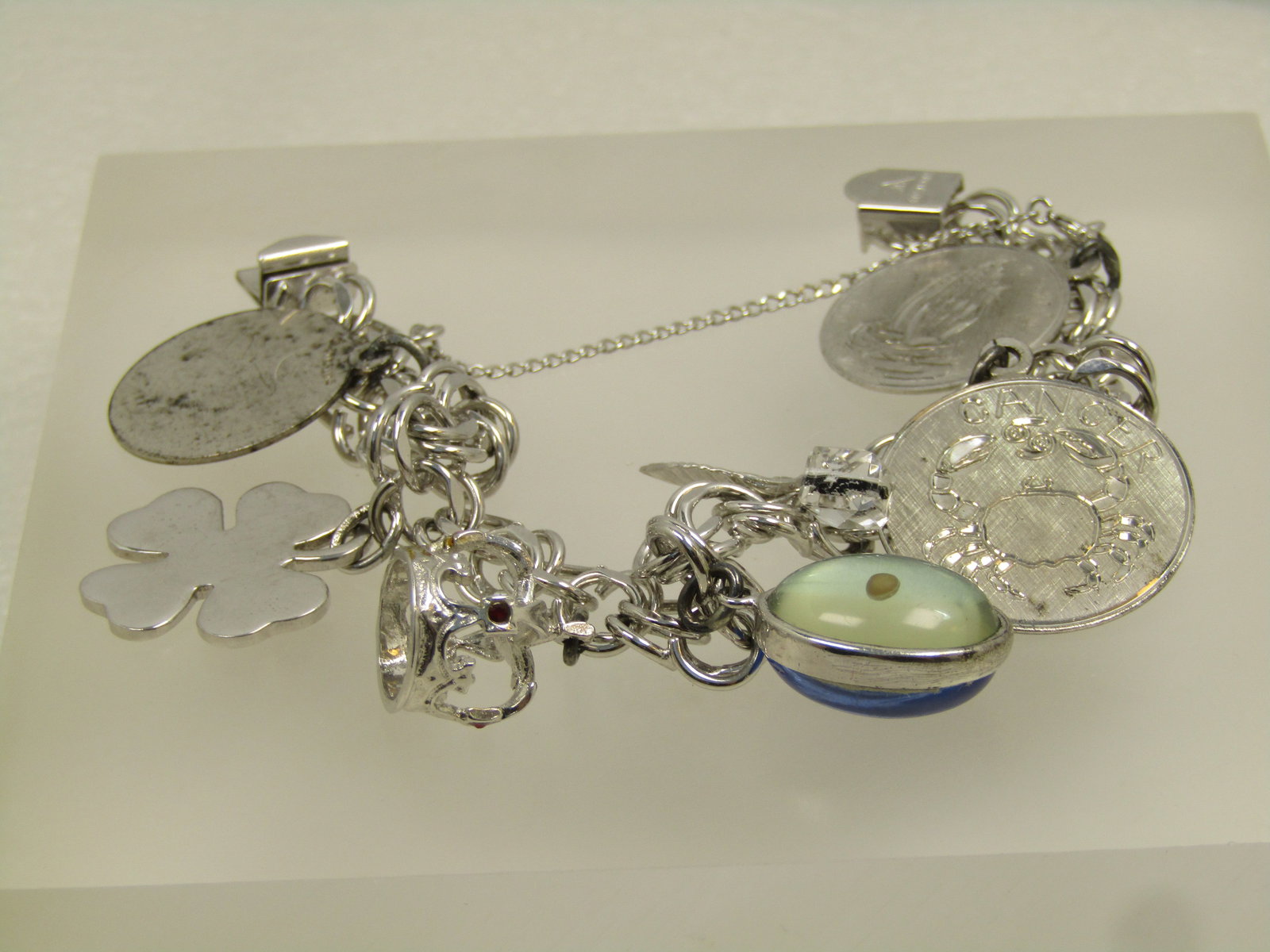 Vintage Sterling Charm Bracelet , 7", Seven Charms, Signed JB, 1960's-1970's: Vintage Sterling Charm Bracelet , 7", Seven Charms, Signed JB, 1960's-1970's. There is a safety chain and bracelet has a box clasp where it is marked sterling and signed JB in a triangular frame. The