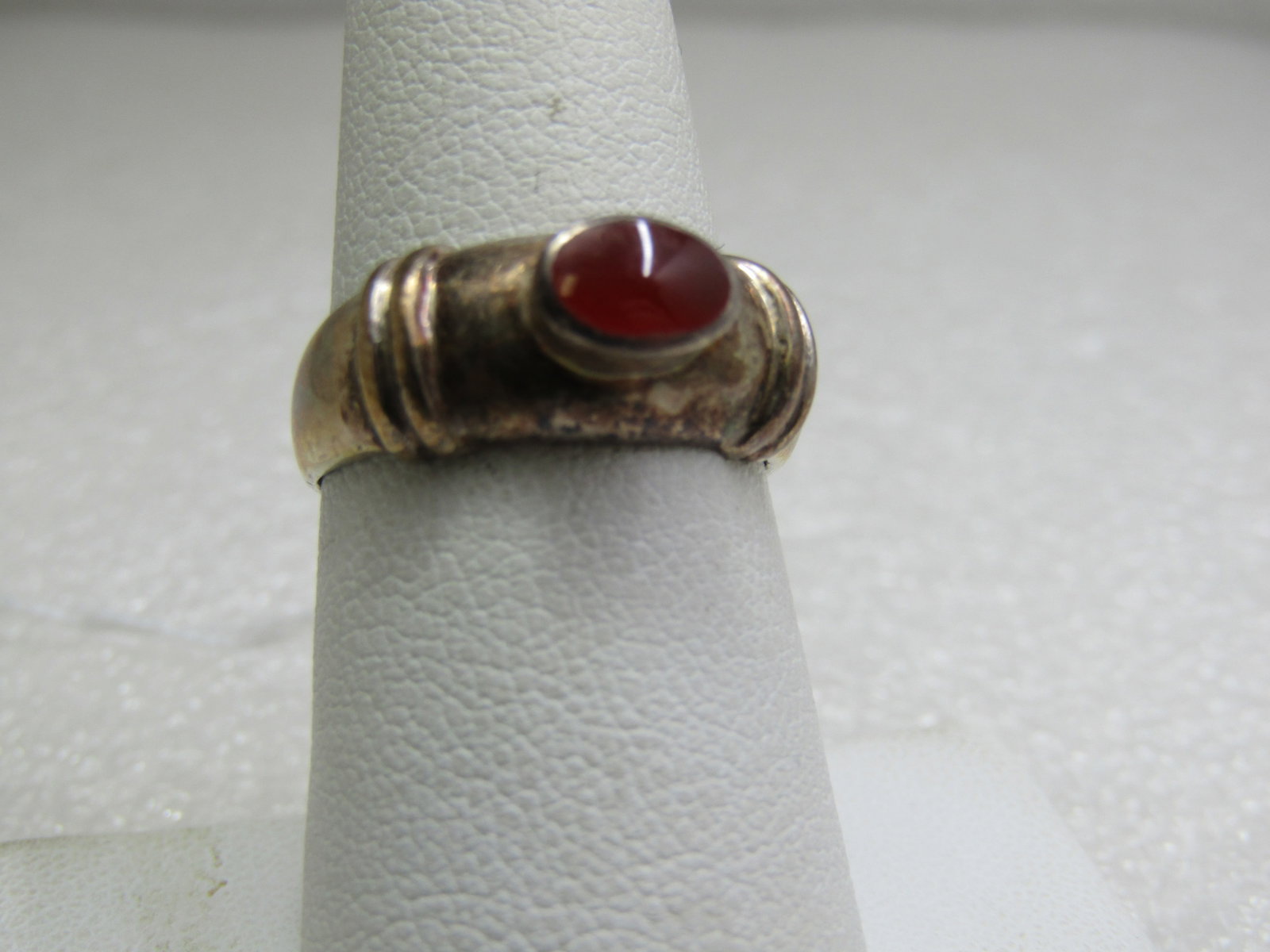 Sterling Carnelian Ring, sz . 7. Appx. 3.25 gr.: Sterling Carnelian Ring, sz . 7. Appx. 3.25 gr. 1980's-1990's., Boho/Southwestern Appeal. 8mm wide on top and appx. 3mm at the back of the finger. Carnelian is appx. 7mm by 5mm raised setting. Signed