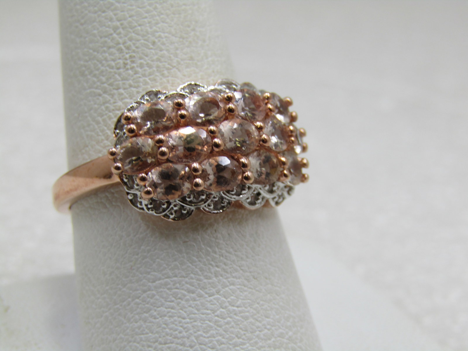 Sterling Peach & Clear CZ Ring, Rose Gold Tone, Sz. 9.5: Sterling Peach & Clear CZ Ring, Rose Gold Tone, Sz. 9.5. There are 13 pale peach stones that are appx. 4mm by 2.5mm set on the side and on each side fo the ring is a silver scalloped setting where a s
