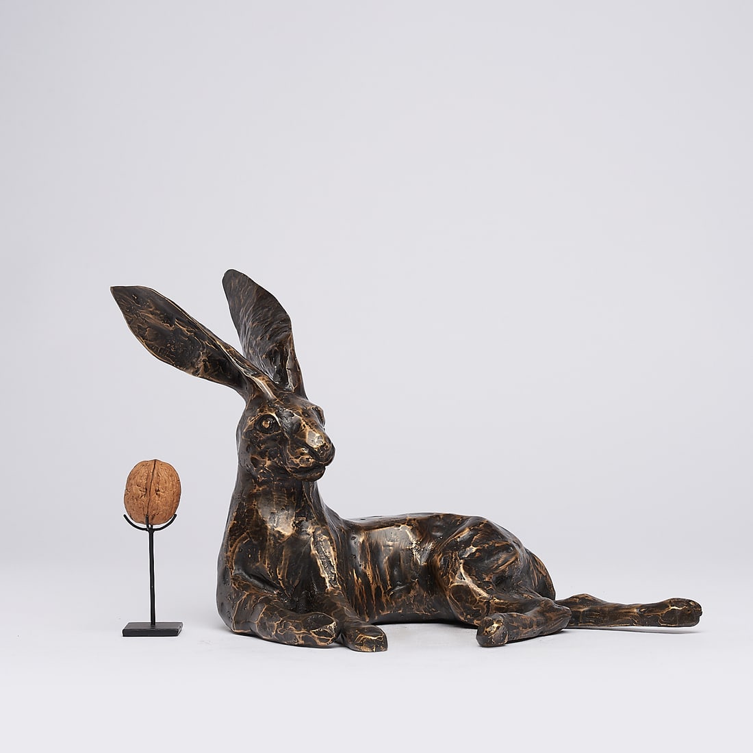 Resting hare ears back: Title: Resting hare ears backMaker:UnknownOrigin: IndonesiaDate/Period:2025Materials:BronzeDimensions:Height: 23 cm / 9 inches Width: 22 cm / 8.6 inchesDescription:This elegant bronze hare sculpture