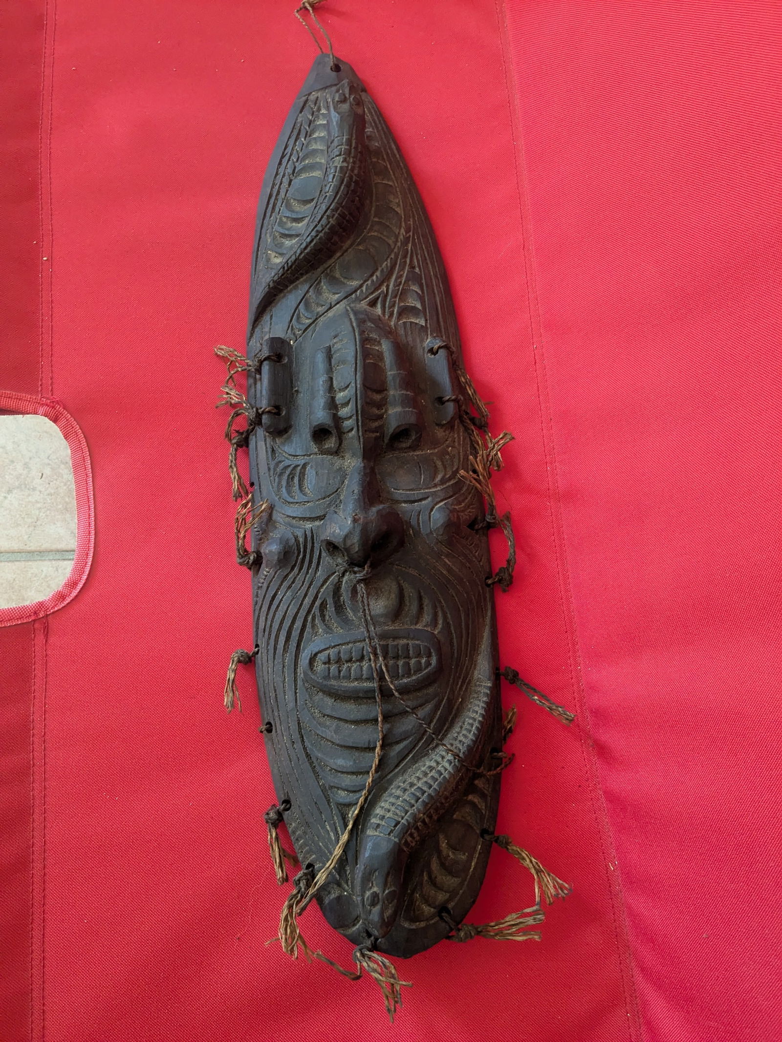 Carved Wooden Mask from Lower Sepik River: Title: Carved Wooden Mask from Lower Sepik River Description:The mask has 2 river creatures, one on the forehead and one on the chin, with knotted bush rope around the edges Date/Period: Late 20th Cen