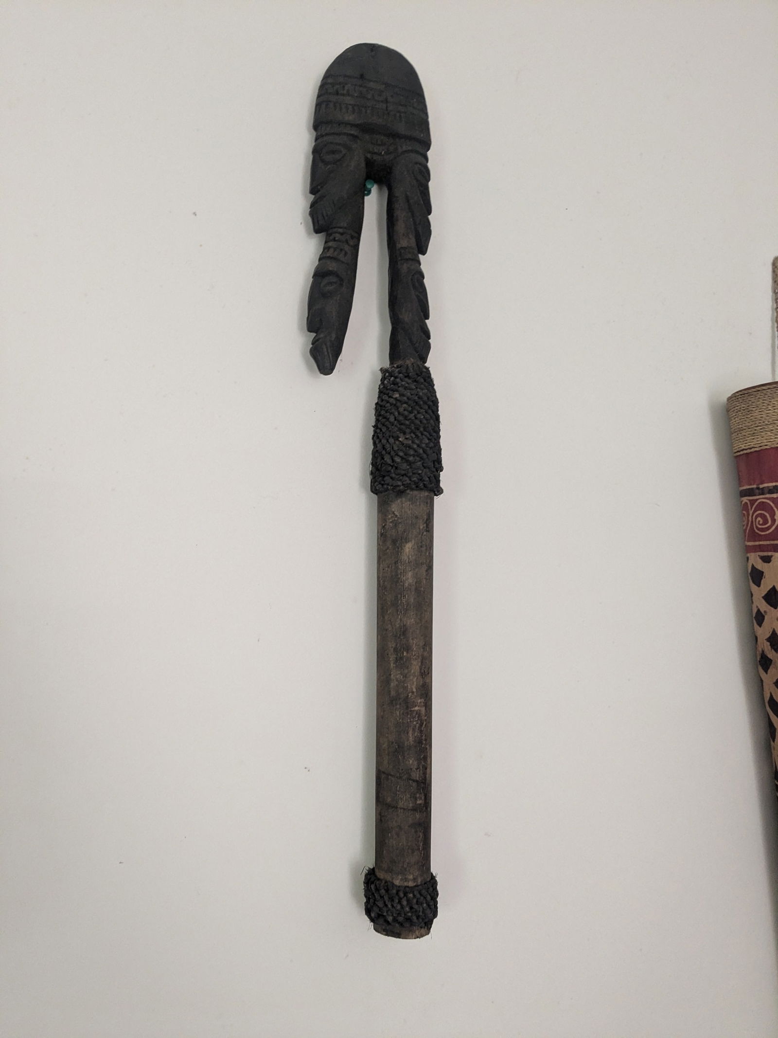 Carved Spirit Hook with Bamboo: Title: Carved Spirit Hook with BambooDescription:Bamboo handle with wood carved ancestor spirits carved on wooden hook attached with woven knotted rattan rope.Date/Period: Late 20th