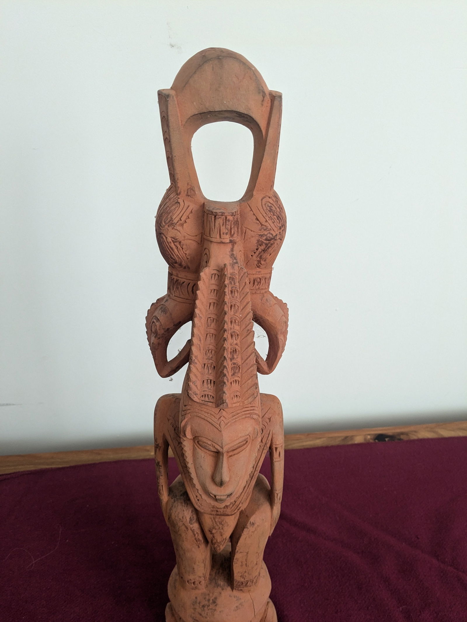 Ancestral Figure: Title: Ancestral FigureDescription:This carved figure is washed with red clay/ochre from the Lower Sepik River, PNG. It has an elaborate head piece with a Horn Bill bird on each side.Date/Period: